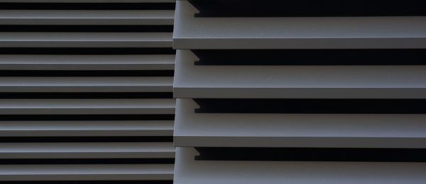 A close up view of 2 Maximair extruded natural ventilation louvres painted grey