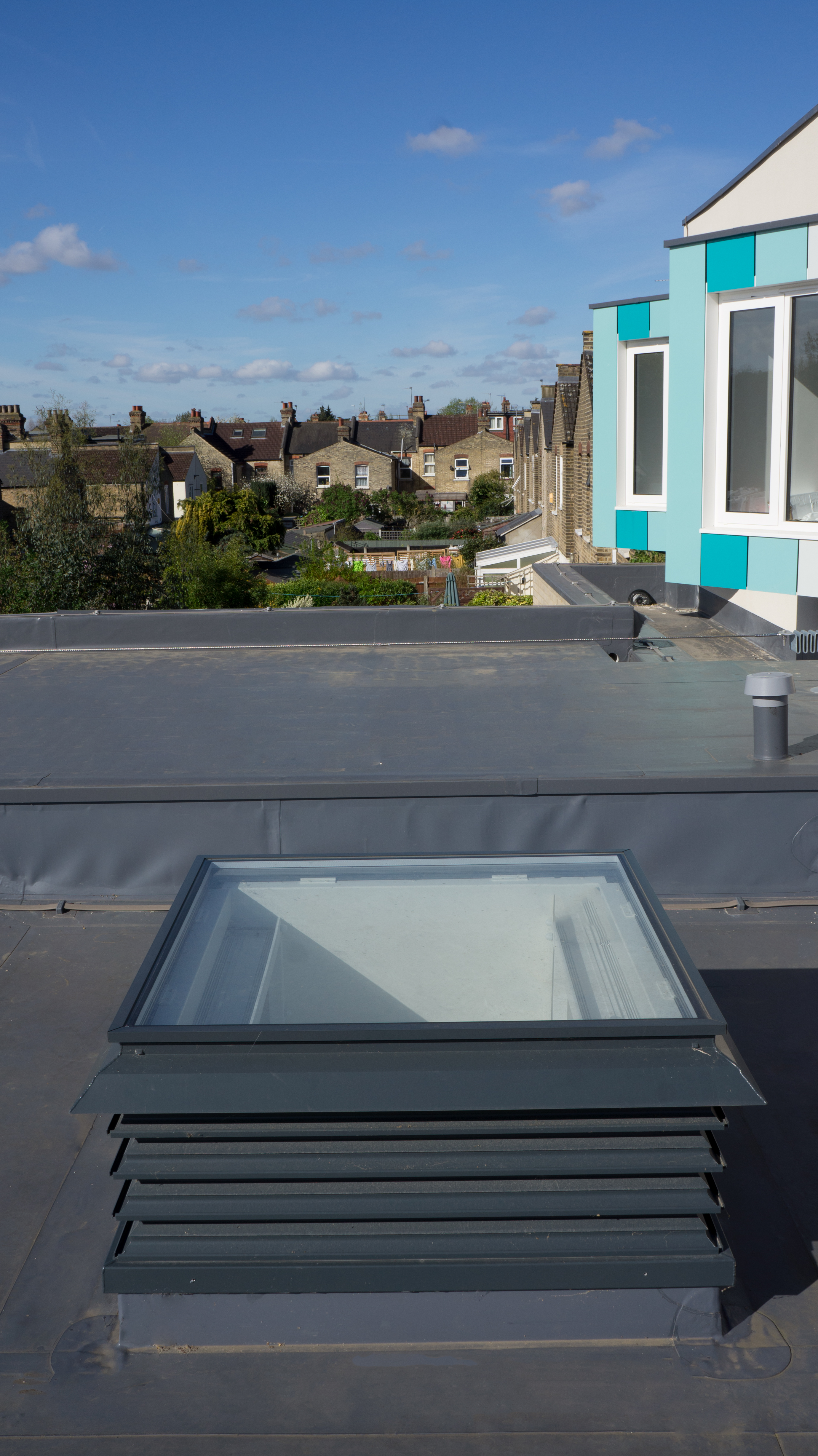 A single natural ventilation louvre rooflight turret painted grey and installed into a school in London