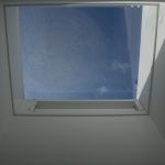 An internal view of a natural ventilation louvre rooflight turret painted white and installed into a school in London
